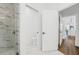 Small bathroom with toilet and shower, white walls, and marble flooring at 460 87Th Avenue North, St Petersburg, FL 33702