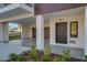 Modern entryway to a townhome with wood garage door at 460 87Th Avenue North, St Petersburg, FL 33702