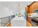 Modern kitchen with a large island, wood cabinets, and white countertops at 484 87Th Avenue North, St Petersburg, FL 33702