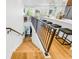 Modern staircase with metal railing overlooking the kitchen and living areas at 484 87Th Avenue North, St Petersburg, FL 33702