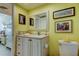 Clean bathroom with vanity and yellow walls at 4900 Brittany S Dr # 608, St Petersburg, FL 33715