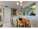 Charming dining area with wood table and white chairs, adjacent to kitchen at 4900 Brittany S Dr # 608, St Petersburg, FL 33715