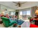 Spacious living room with green sofa, glass coffee table and water views at 4900 Brittany S Dr # 608, St Petersburg, FL 33715