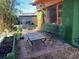 Relaxing backyard patio with chairs, a table, and colorful plants near the charming home exterior at 5209 10Th S Ave, Gulfport, FL 33707