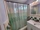 Bathroom with shower/tub combo, vanity, and checkered tile at 5209 10Th S Ave, Gulfport, FL 33707