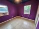 Bedroom with purple walls, tile floors, and window at 5209 10Th S Ave, Gulfport, FL 33707