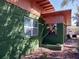 Green house exterior with orange trim, featuring a window and small patio area at 5209 10Th S Ave, Gulfport, FL 33707