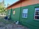 Green house exterior with orange trim and multiple windows at 5209 10Th S Ave, Gulfport, FL 33707