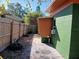 Side view of green house with orange accents and wooden fence at 5209 10Th S Ave, Gulfport, FL 33707