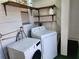 Laundry room with washer, dryer, and shelving units at 5209 10Th S Ave, Gulfport, FL 33707