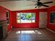 Bright living room with tiled floors, a brick fireplace, and ample natural light from surrounding windows at 5209 10Th S Ave, Gulfport, FL 33707