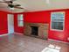 Bright living room with a brick fireplace, tiled floor, and windows offering natural light at 5209 10Th S Ave, Gulfport, FL 33707