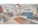 Living room with teal sofa, coffee table, and ceiling fan at 5258 Beach Se Dr, St Petersburg, FL 33705