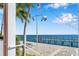 Scenic waterfront view with a dock and palm trees at 5258 Beach Se Dr, St Petersburg, FL 33705