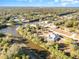 An aerial view showcasing a neighborhood with houses near a canal at 5366 Hader Rd, North Port, FL 34288