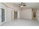 Spacious bedroom with tile floors, ceiling fan, and door to bathroom at 5366 Hader Rd, North Port, FL 34288