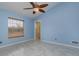 Light blue bedroom with tile flooring and window at 5366 Hader Rd, North Port, FL 34288