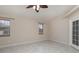 Large bedroom with tile floors, ceiling fan, and access to exterior at 5366 Hader Rd, North Port, FL 34288