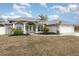 Two-story house with a landscaped yard and palm trees at 5366 Hader Rd, North Port, FL 34288