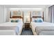 Two double beds in a hotel bedroom with coastal decor at 5500 Gulf Blvd # 2240, St Pete Beach, FL 33706