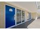 Exterior view of condo building showcasing blue doors and windows at 5500 Gulf Blvd # 2240, St Pete Beach, FL 33706