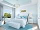 Main bedroom with white bed, light blue accents, and large window at 6708 Burlington Ave, St Petersburg, FL 33710