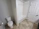 Clean bathroom with tub, toilet and tile flooring at 7041 Spotted Deer Pl, Riverview, FL 33569