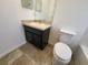 Clean bathroom with dark vanity and tile floor at 7041 Spotted Deer Pl, Riverview, FL 33569