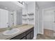 Bathroom with a large mirror, vanity with dark cabinetry, and a shower/tub combination at 7041 Spotted Deer Pl, Riverview, FL 33569