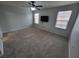 Bright bedroom featuring carpet, ceiling fan, and window at 7041 Spotted Deer Pl, Riverview, FL 33569