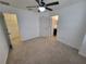 Spacious bedroom with ceiling fan and adjacent bathroom and closet at 7041 Spotted Deer Pl, Riverview, FL 33569