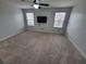 Spacious bedroom with ceiling fan, carpet, and large windows at 7041 Spotted Deer Pl, Riverview, FL 33569