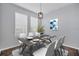 Dining room with a modern light fixture, stylish decor, and natural light from two windows at 7041 Spotted Deer Pl, Riverview, FL 33569