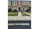 Two-story townhome with teal doors and walkway at 7041 Spotted Deer Pl, Riverview, FL 33569