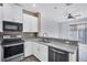 Well-equipped kitchen featuring stainless steel appliances, granite countertops, and modern cabinetry at 7041 Spotted Deer Pl, Riverview, FL 33569