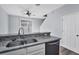 Stainless dual sink with granite countertop and modern faucet fixture overlooks dining area at 7041 Spotted Deer Pl, Riverview, FL 33569