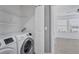 Convenient laundry area with modern machines and overhead shelving at 7041 Spotted Deer Pl, Riverview, FL 33569