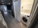 Laundry room with washer and dryer and extra storage at 7041 Spotted Deer Pl, Riverview, FL 33569