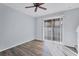 Living Room featuring wood laminate flooring, ceiling fan, and sliding glass doors to outdoor living at 7041 Spotted Deer Pl, Riverview, FL 33569