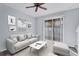 Bright living room with sliding glass doors, ceiling fan, and neutral decor for a contemporary aesthetic at 7041 Spotted Deer Pl, Riverview, FL 33569