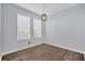 Clean, naturally lit living room with hardwood flooring and modern fixtures at 7041 Spotted Deer Pl, Riverview, FL 33569