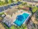 Aerial view of a community pool with lounge chairs and nearby parking in a well-maintained neighborhood at 7041 Spotted Deer Pl, Riverview, FL 33569