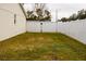 Private backyard with a grassy area and white fence at 7097 Aberfeldy N Ave, St Petersburg, FL 33709