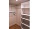 White closet with shelves and hanging rod at 7097 Aberfeldy N Ave, St Petersburg, FL 33709