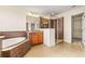 Bathroom with granite vanity, shower, and soaking tub at 7119 Peregrina Loop, Wesley Chapel, FL 33545