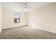 Well-lit bedroom with carpeted floors and a large window at 7119 Peregrina Loop, Wesley Chapel, FL 33545