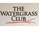 The Watergrass Club sign, elegant lettering on a light background at 7119 Peregrina Loop, Wesley Chapel, FL 33545