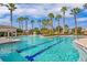 Resort-style pool with palm trees and a clubhouse at 7119 Peregrina Loop, Wesley Chapel, FL 33545