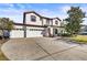 Two story house with a two car garage and manicured lawn at 7119 Peregrina Loop, Wesley Chapel, FL 33545