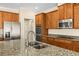 Kitchen island with double sink and stainless steel appliances at 7119 Peregrina Loop, Wesley Chapel, FL 33545